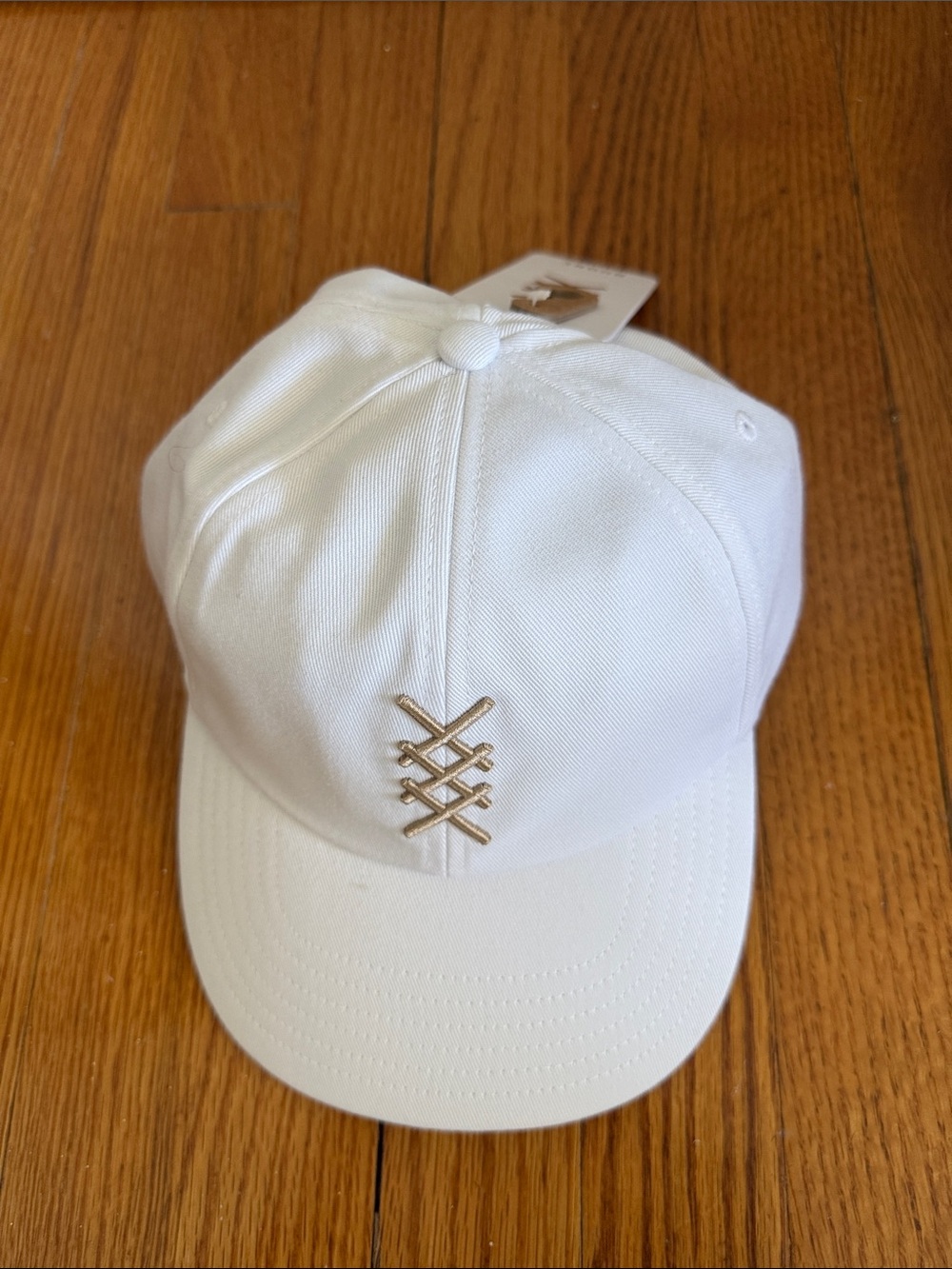 RHONE White Baseball Cap with Gold Logo